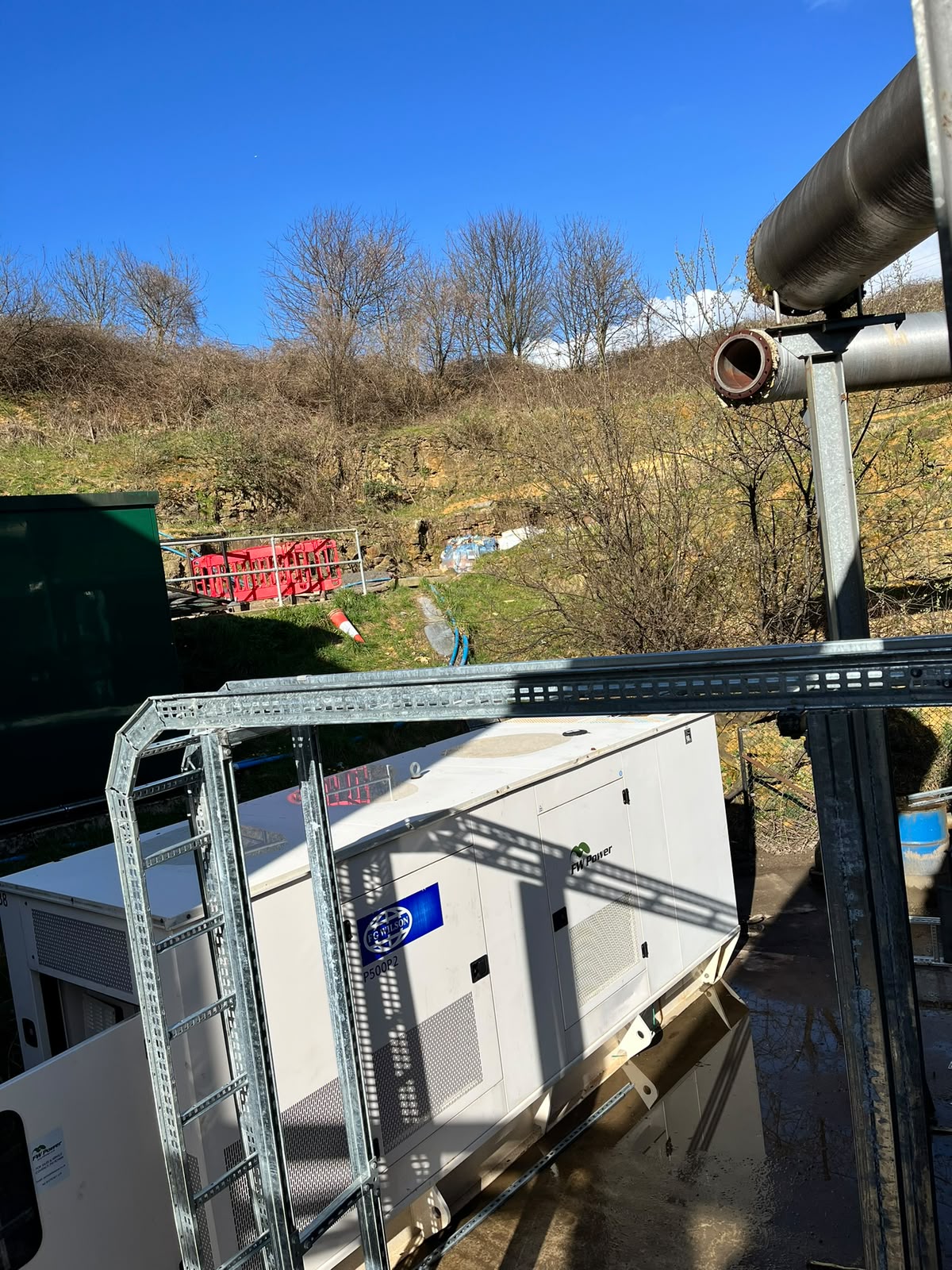 Commercial standby generator installed beside an operational anaerobic digestion plant