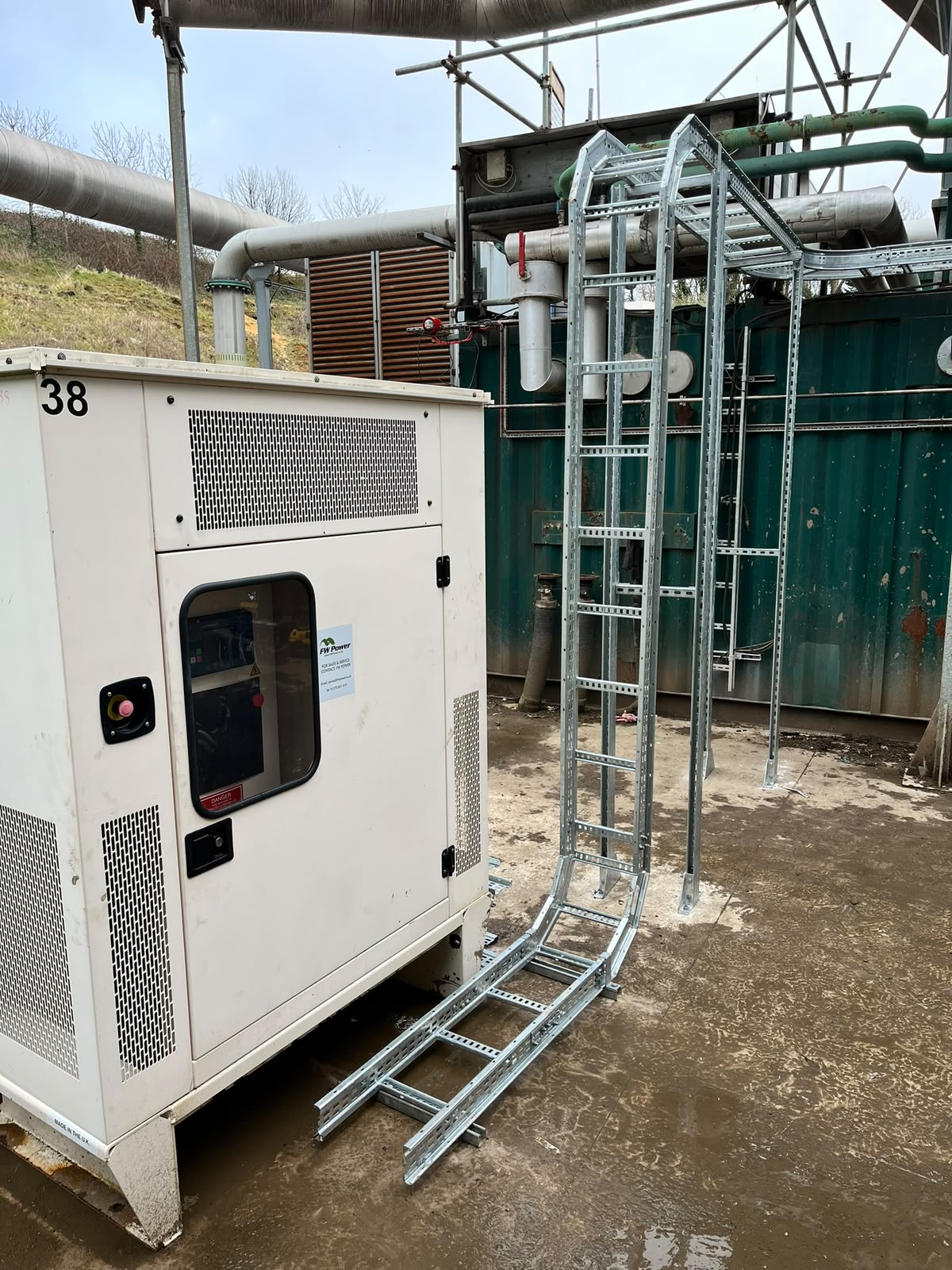 Generator and cable containment beside process pipework