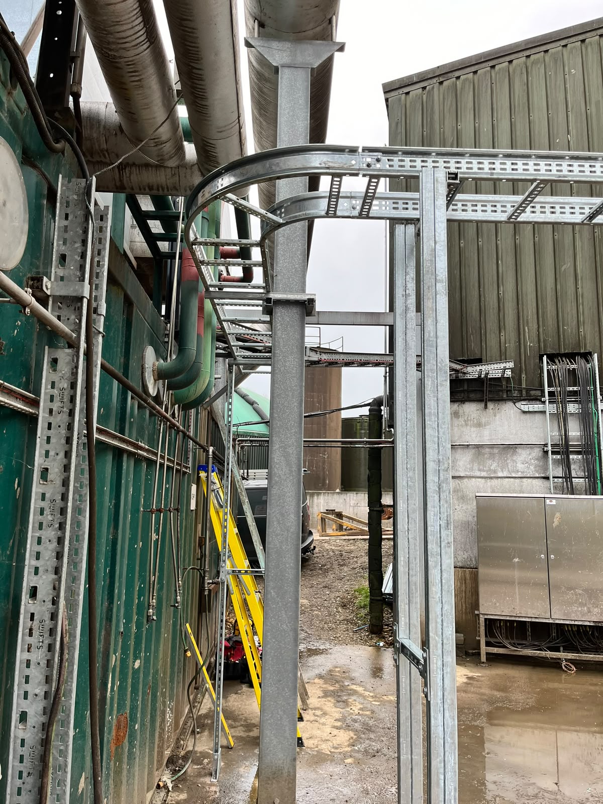 Cable containment rising beside the industrial building